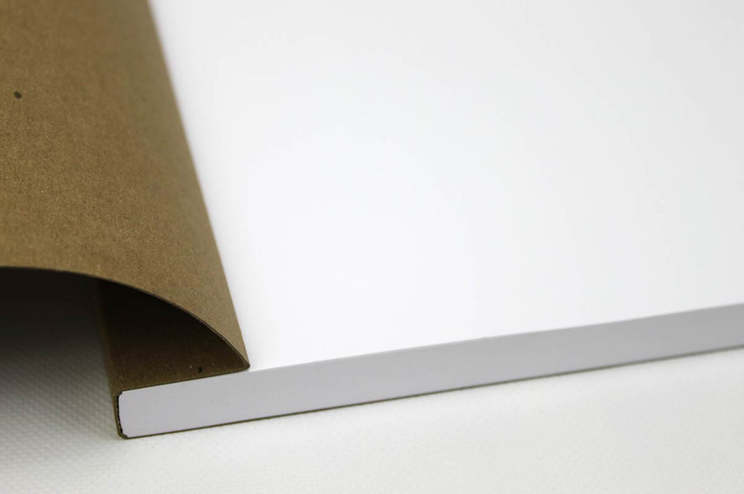 Close up of the binding of an open chicago screw notebook with kraft brown cover and white pages.