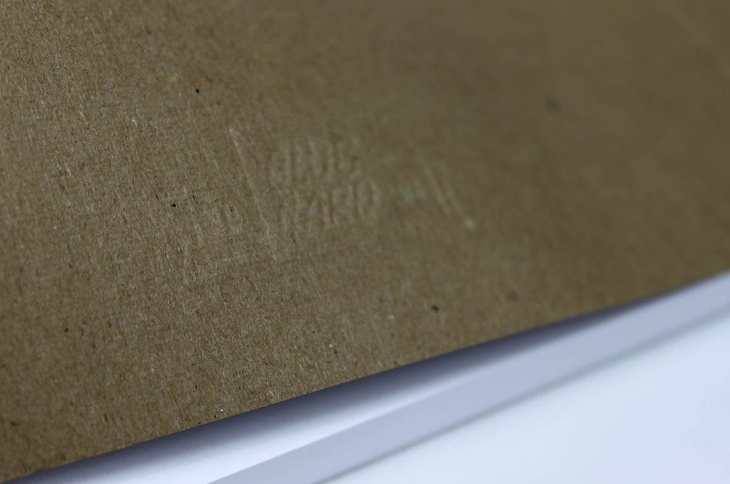 Close up of the embossed Clubcard branding on the back of a chicago screw notebook with kraft brown cover and white pages.