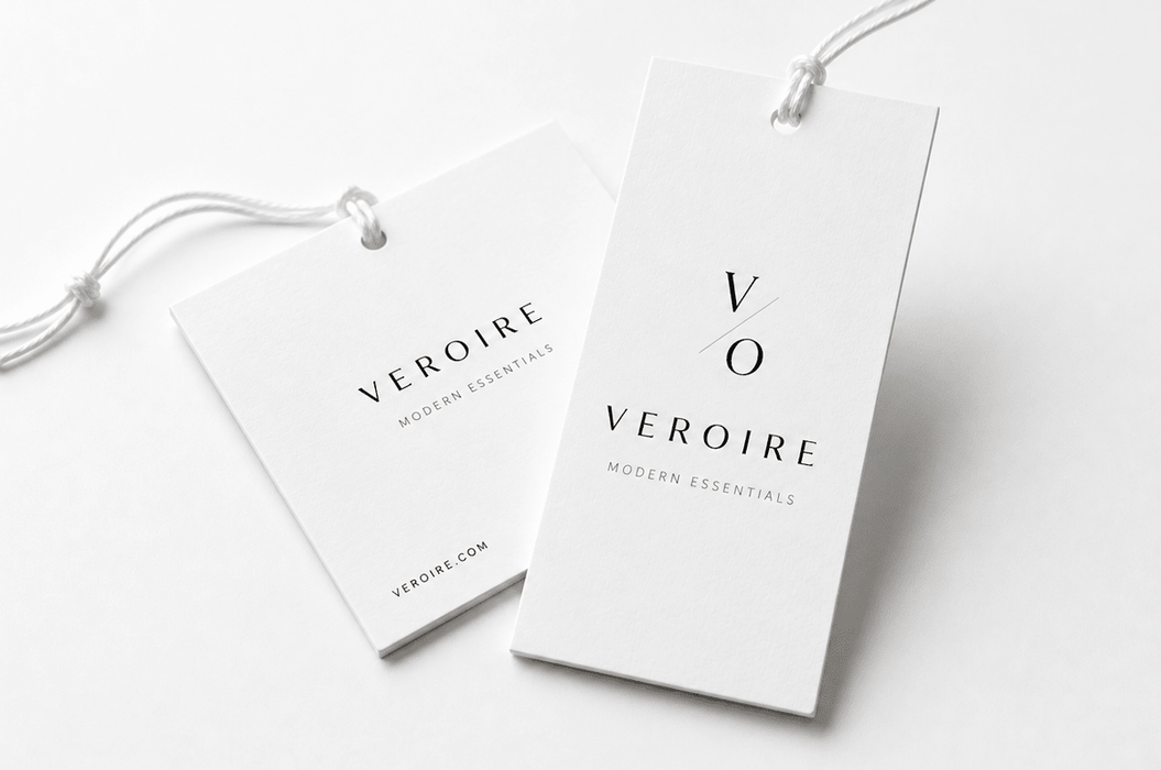 Extra thick minimalist 24pt recycled uncoated apparel hang tags printed by Clubcard Vancouver for Veroire Modern Essentials featuring white cord strings