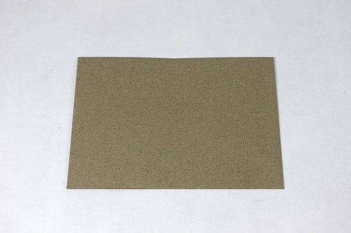 Front view of a single blank sand-brown Desert Storm kraft envelope laying flat on a light textured background.