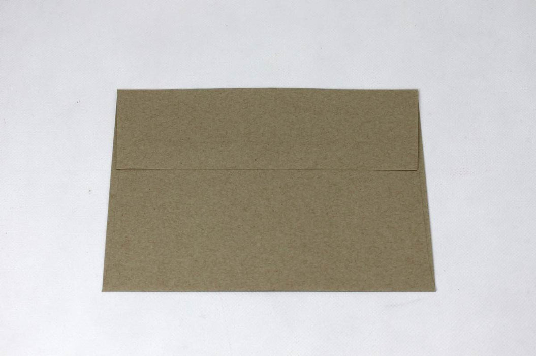 Front view of a single blank sand-brown Desert Storm kraft envelope laying flat on a light textured background.