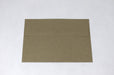 Front view of a single blank sand-brown Desert Storm kraft envelope laying flat on a light textured background.