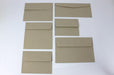 Flat lay grid displaying six blank sand-brown Desert Storm kraft envelopes in assorted sizes on a light background.