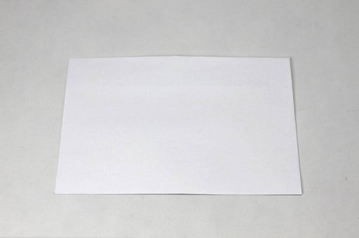 Single blank white wove envelope laying flat on a light textured background.