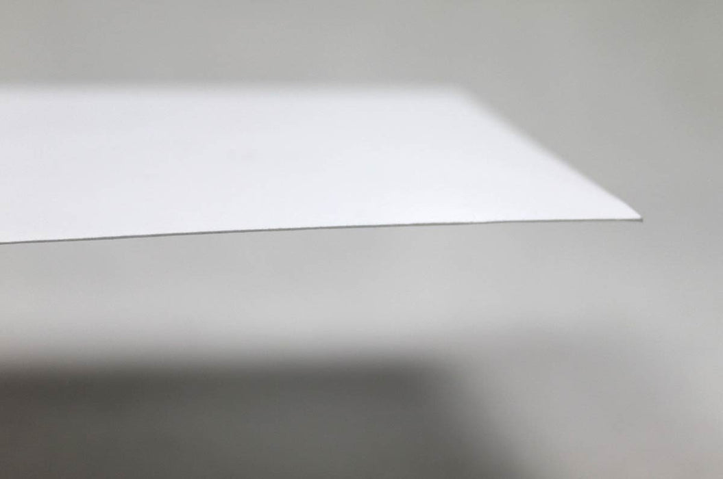 Macro close-up shot showing the edge and smooth paper texture of a 70lb uncoated white envelope