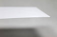 Macro close-up shot showing the edge and smooth paper texture of a 70lb uncoated white envelope