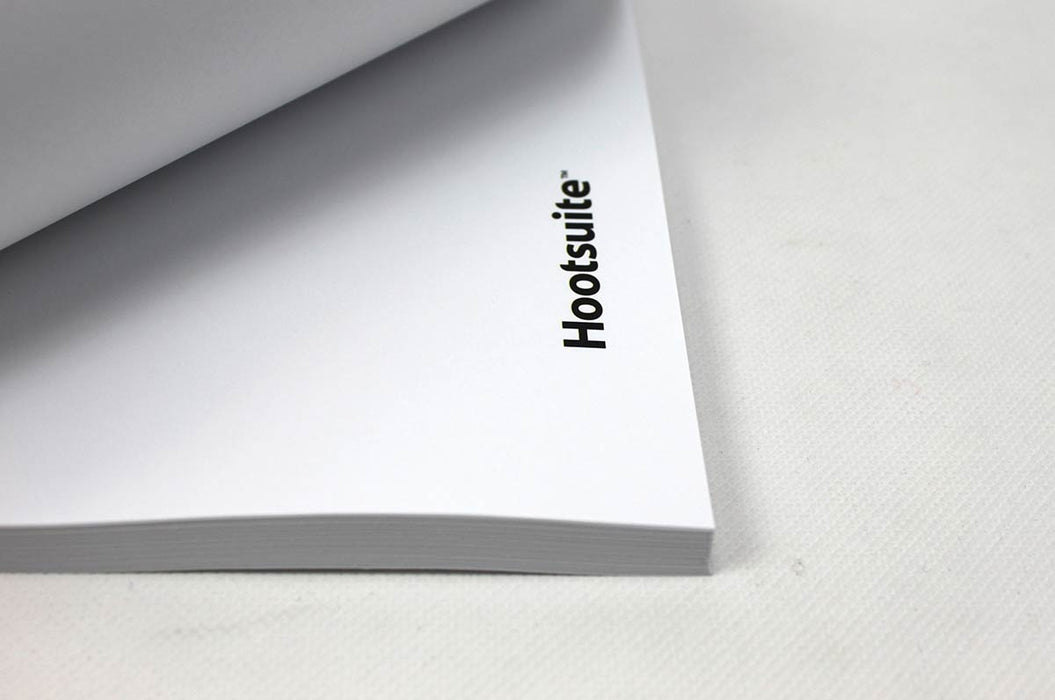 Close-up shot of the corner of a stack of custom printed Hootsuite letterhead sheets showing the logo