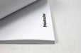 Close-up shot of the corner of a stack of custom printed Hootsuite letterhead sheets showing the logo