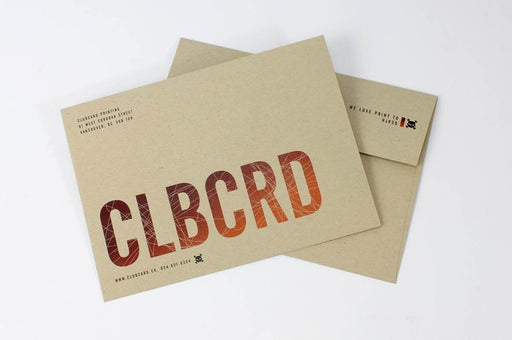Custom printed Desert Storm kraft envelopes with bold red CLBCRD branding and return address on light sand textured paper.