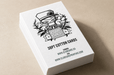 Stack of custom 38pt ultra-thick cotton business cards featuring Clubcard Vancouver's peace man mascot letterpress printed with iridescent foil and black ink set on a neutral background, printed by Clubcard Vancouver