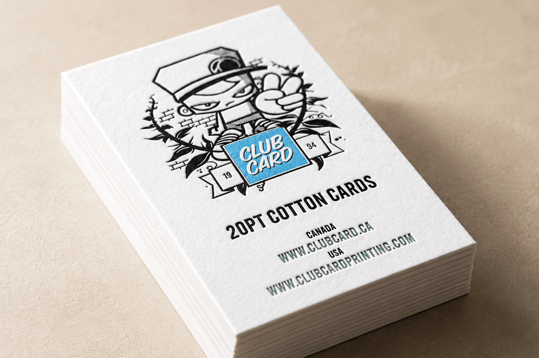 Stack of custom 20pt cotton business cards with the Clubcard logo blind debossed over a metallic blue foil stamped square, printed by Clubcard Vancouver