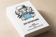 Stack of custom 20pt cotton business cards with the Clubcard logo blind debossed over a metallic blue foil stamped square, printed by Clubcard Vancouver