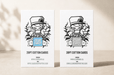 side-by-side comparison of 20pt and 38pt cotton letterpress business cards featuring Clubcard Vancouver's peace man mascot, with the 20pt card on the left featuring a blind debossed logo over a metallic blue foil square and the 38pt card on the right featuring a blind debossed logo over an iridescent foil square, printed by Clubcard Vancouver