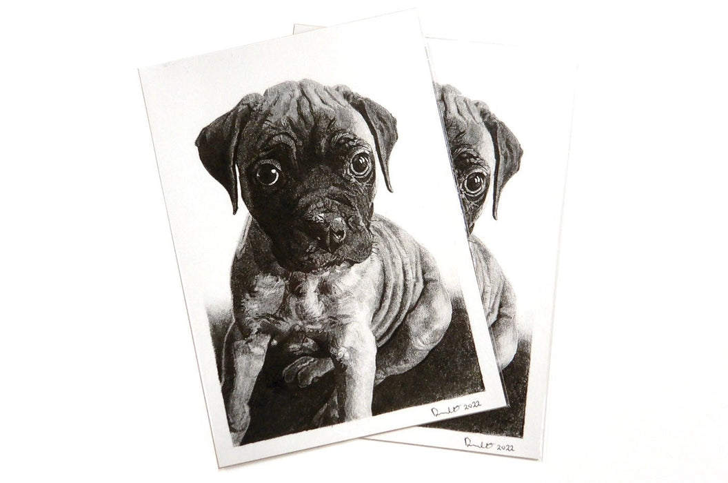 Two fine art photography prints featuring a black and white puppy portrait, printed by Clubcard Vancouver