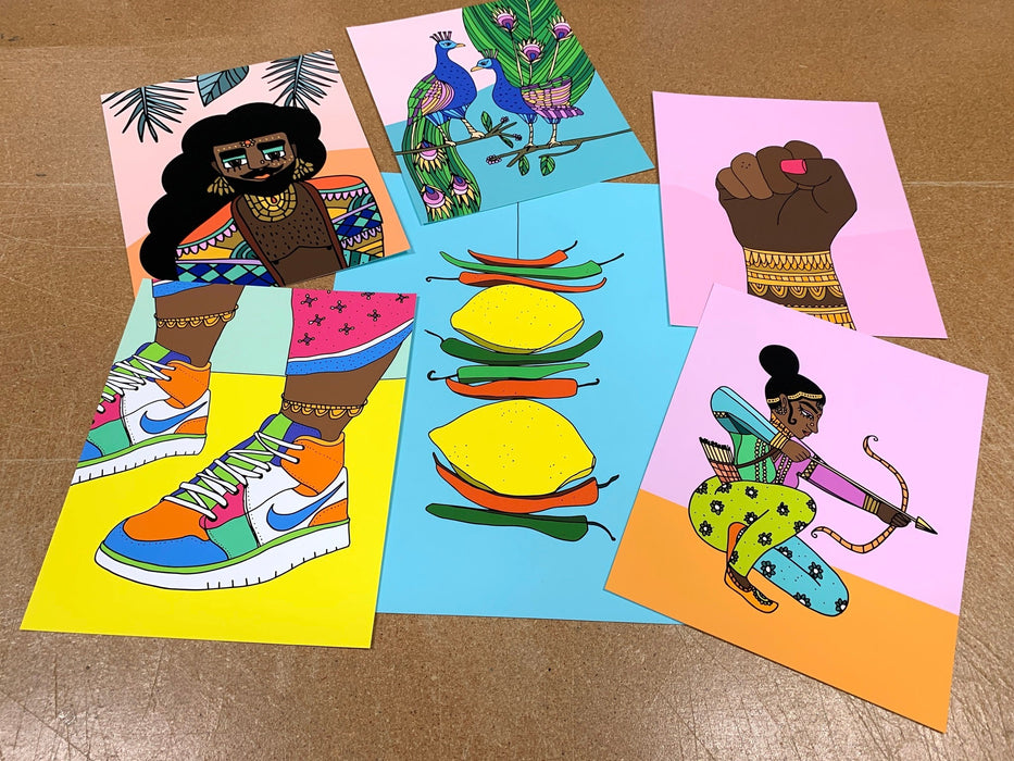 Multiple fine art sample prints featuring colorful diverse character and bird illustrations, by artist Jag Nagra, printed by Clubcard Vancouver