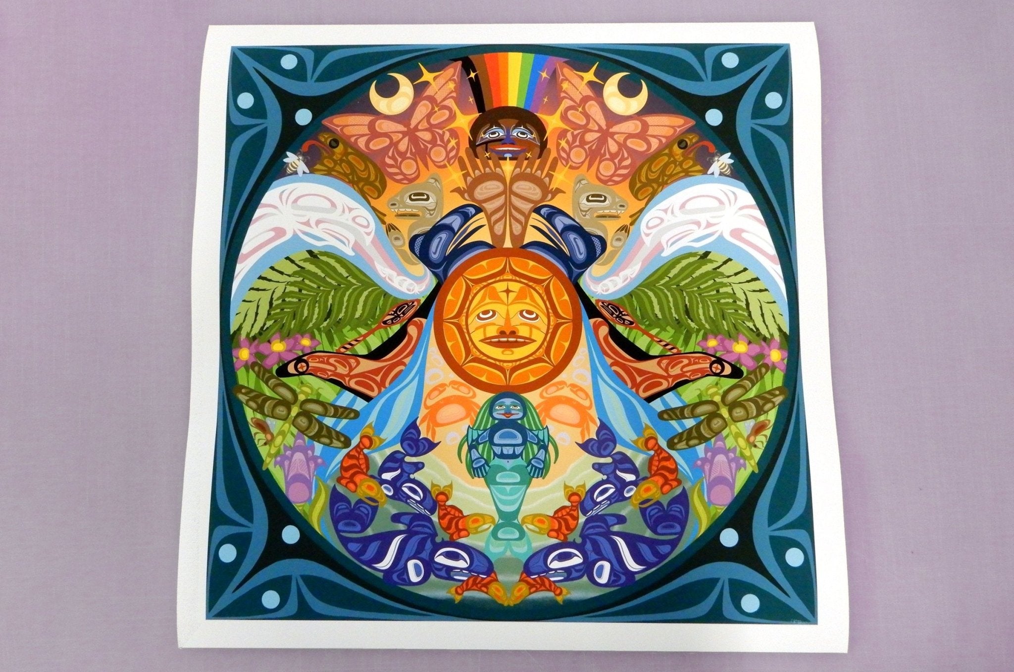 Large fine art print sample featuring a vibrant, intricate colourful mandala artwork with a central sun motif, printed by Clubcard Vancouver