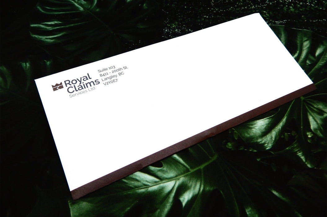 Custom printed Royal Claims Services Ltd. No. 10 uncoated envelope displayed on a green leafy background