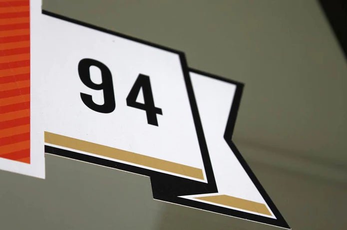 Close up view of custom printed vinyl window sticker showing detailed flag emblem with number ninety four