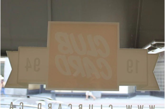 Interior reverse view of a custom printed vinyl window sticker applied to glass showing translucent backing