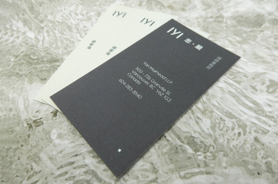 Fan display of black and white business cards printed on 16pt bamboo card stoc