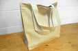 Heavyweight 12oz natural cotton canvas tote bag with side and bottom gusset standing on a wood surface - Clubcard Vancouver