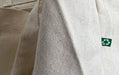Close-up of recycled cotton canvas tote bag fabric texture with green recycling tag - Clubcard Vancouver