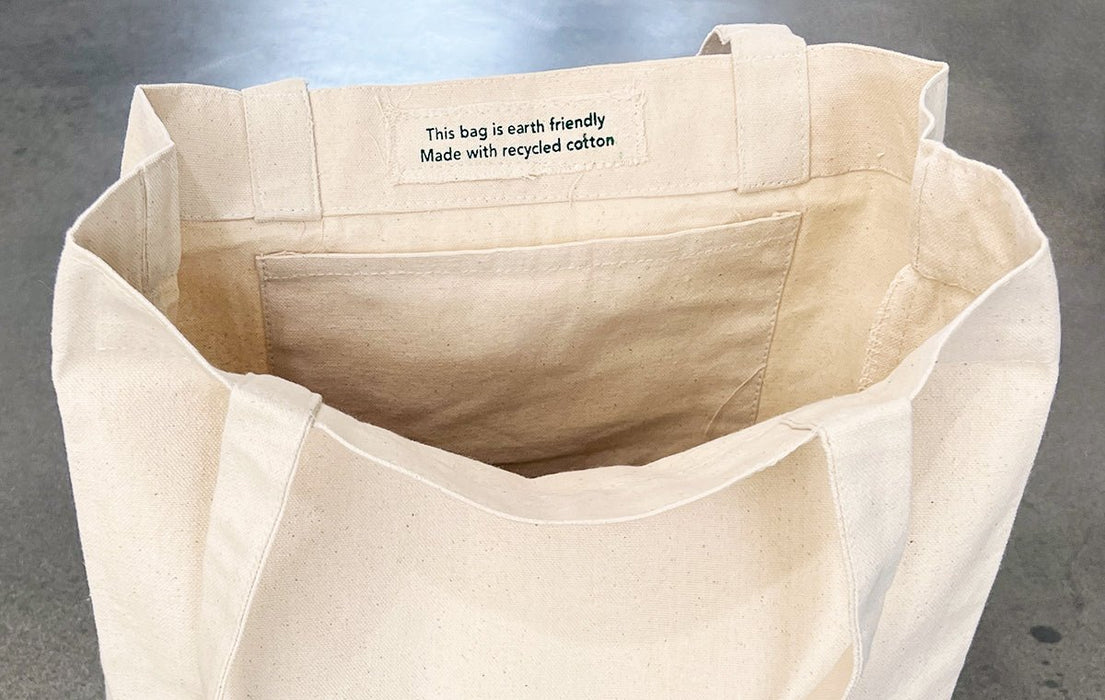 Interior view of a heavyweight recycled cotton canvas tote bag showing the inside pocket and fabric tag - Clubcard Vancouver