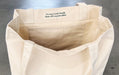 Interior view of a heavyweight recycled cotton canvas tote bag showing the inside pocket and fabric tag - Clubcard Vancouver