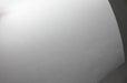 Close-up view of a curved sheet of white 70lb linen uncoated letterhead showing its textured surface.