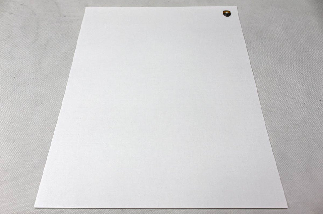 Extreme close-up macro view showing the cloth-like woven texture of white 70lb linen uncoated letterhead paper.