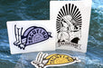Custom shape vinyl sticker samples featuring black and yellow Tacofino logo graphics on a blue ocean background, printed by Clubcard Vancouver