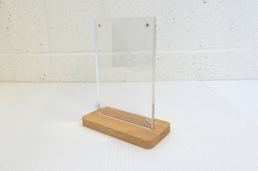Tabletop quick-change acrylic 4x6 sign and menu holder with corner magnets mounted in a wooden base
