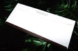 Back flap view of a custom printed Royal Claims Services Ltd. No. 10 uncoated envelope on a dark leafy background