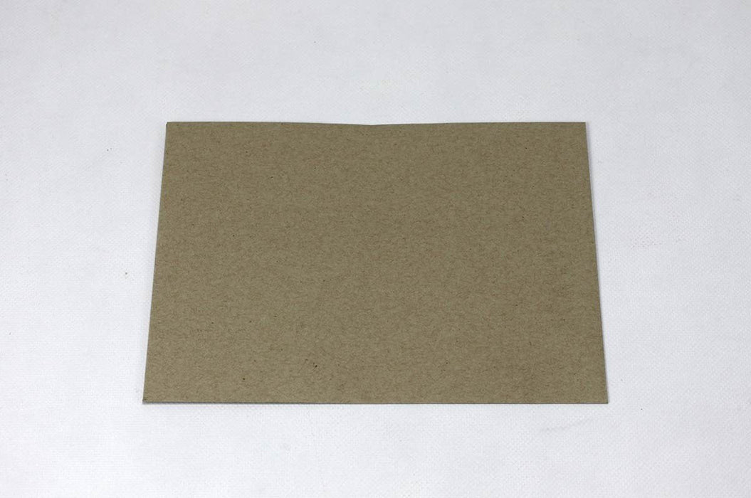 Front view of a single blank sand-brown Desert Storm kraft envelope laying flat on a light textured background.