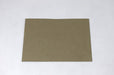Front view of a single blank sand-brown Desert Storm kraft envelope laying flat on a light textured background.