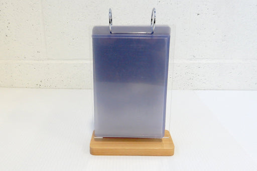 Tabletop acrylic flip menu stand with 5.75 x 8 inch clear pockets and metal binder rings on a wooden base