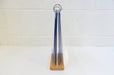 Side profile view of a tabletop acrylic flip menu stand holding multiple 5.75 x 8 inch clear display pockets on a wooden base