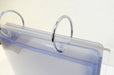 Close-up view of metal binder rings on a tabletop acrylic flip menu stand with 5.75 x 8 inch clear display pockets