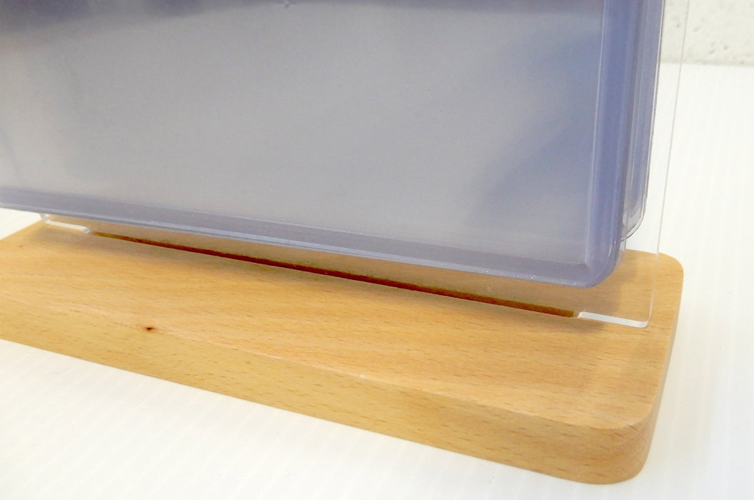 Side profile view of a wooden base supporting a tabletop acrylic flip menu stand with clear display pockets