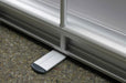 Close-up view of the silver aluminum cassette base and extended stabilizing foot on an extra-large tabletop retractable banner stand.