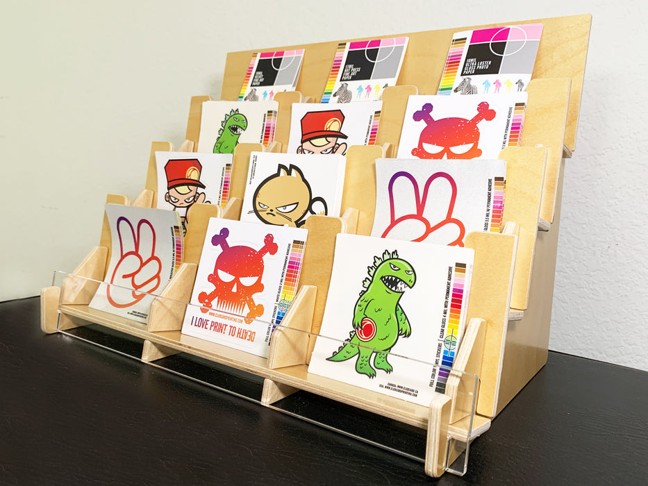 right angle partial side view of 12 pocket sticker display rack made with light colour birchwood and a clear acrylic front with stickers in each pocket