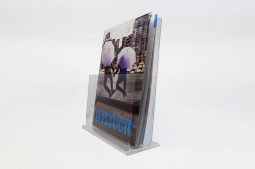 Clear acrylic sell sheet display stand holding the 8.5" x 11" publication City Studio 2016-2017.