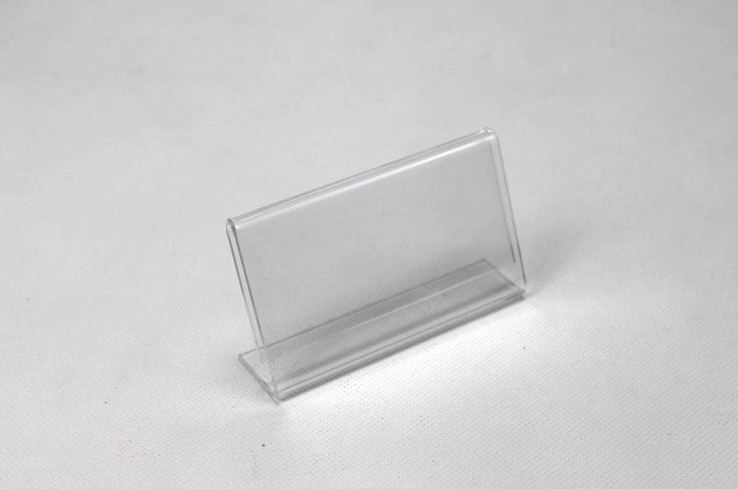 Clear acrylic business card frame on a white background.
