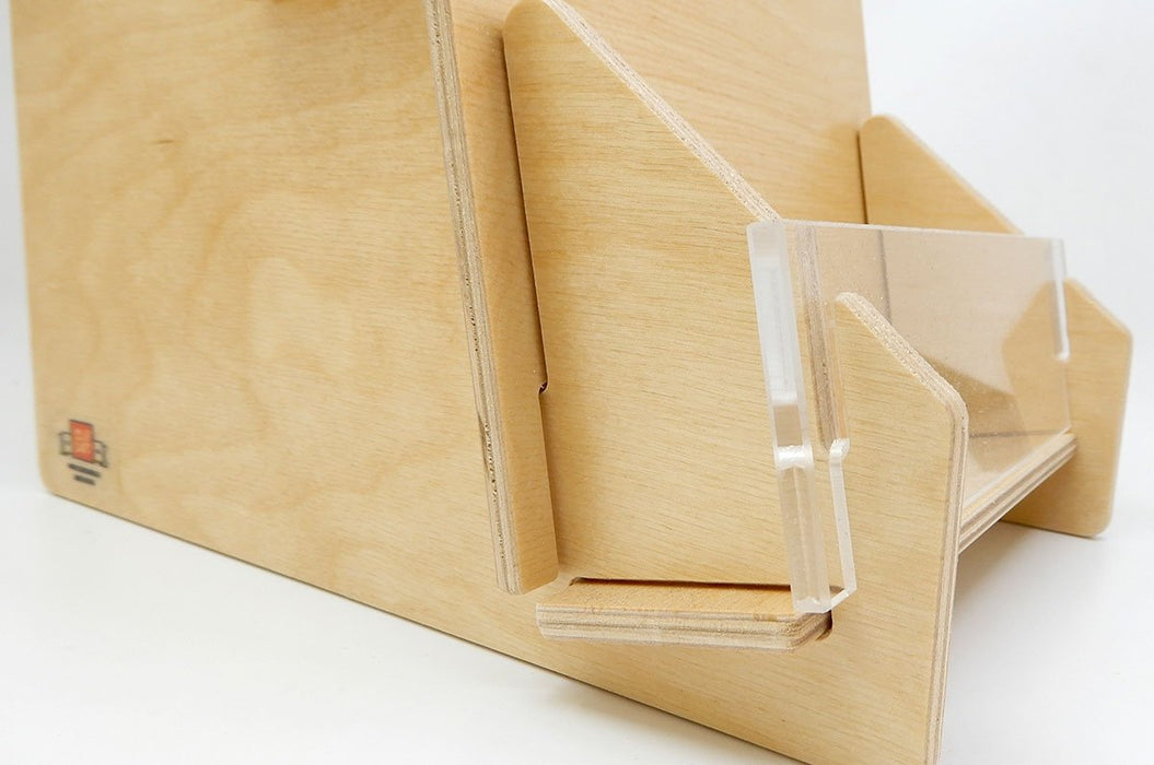 Close up of the corner of a slim birch plywood card display stand with front acrylic panel and Clubcard logo.