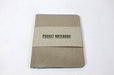Natural kraft pocket notebook with white pages packaged in a clear plastic film and a paper band.