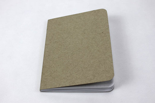 Front of a natural kraft pocket notebook with white dotted pages.