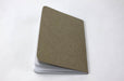 Back of a natural kraft pocket notebook with white dotted pages and embossed Clubcard logo on the cover.